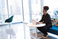 a woman working on a laptop in an office